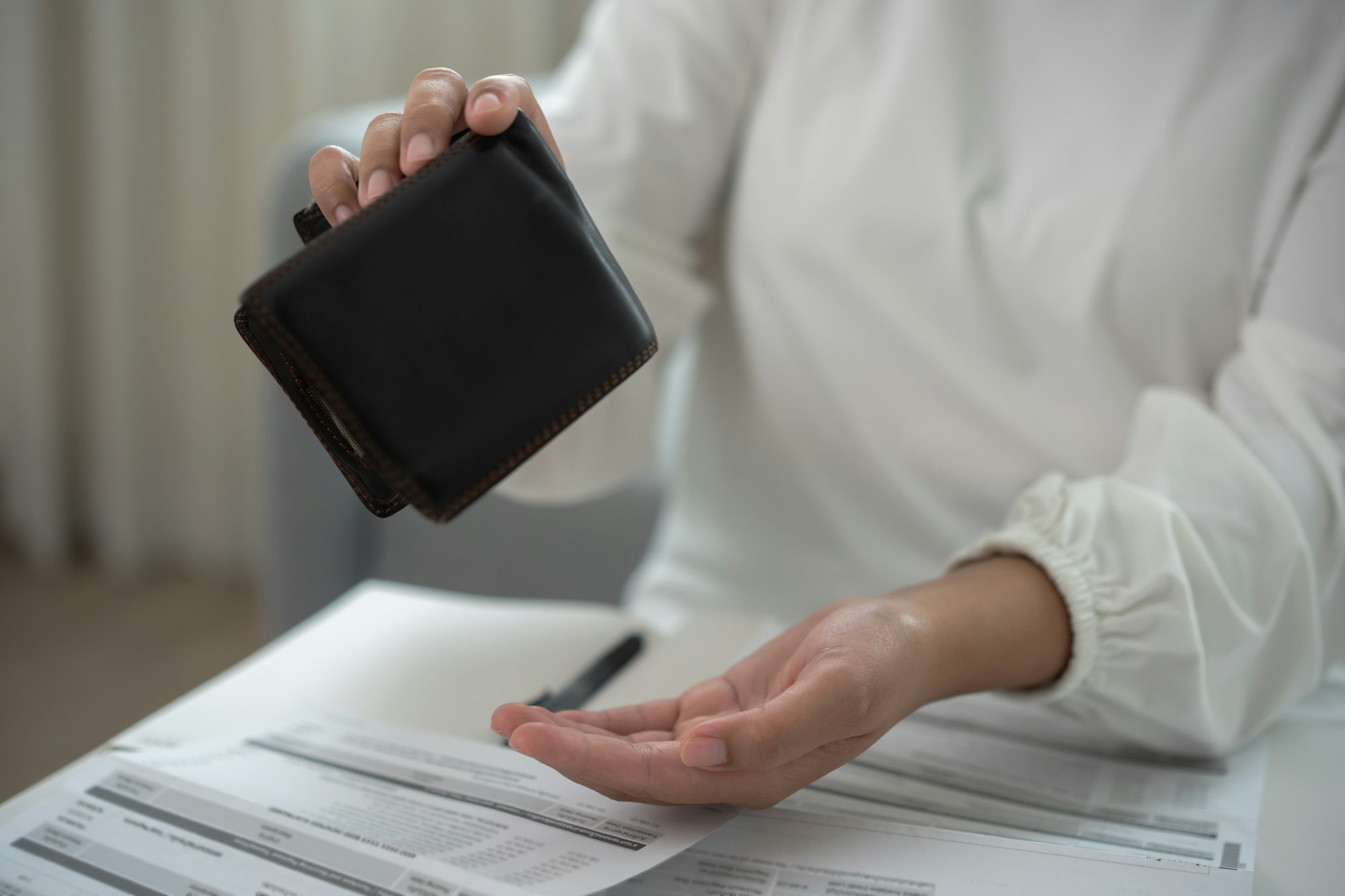 Worried unemployment woman open empty wallet on payday Worried unemployment woman open empty wallet on payday