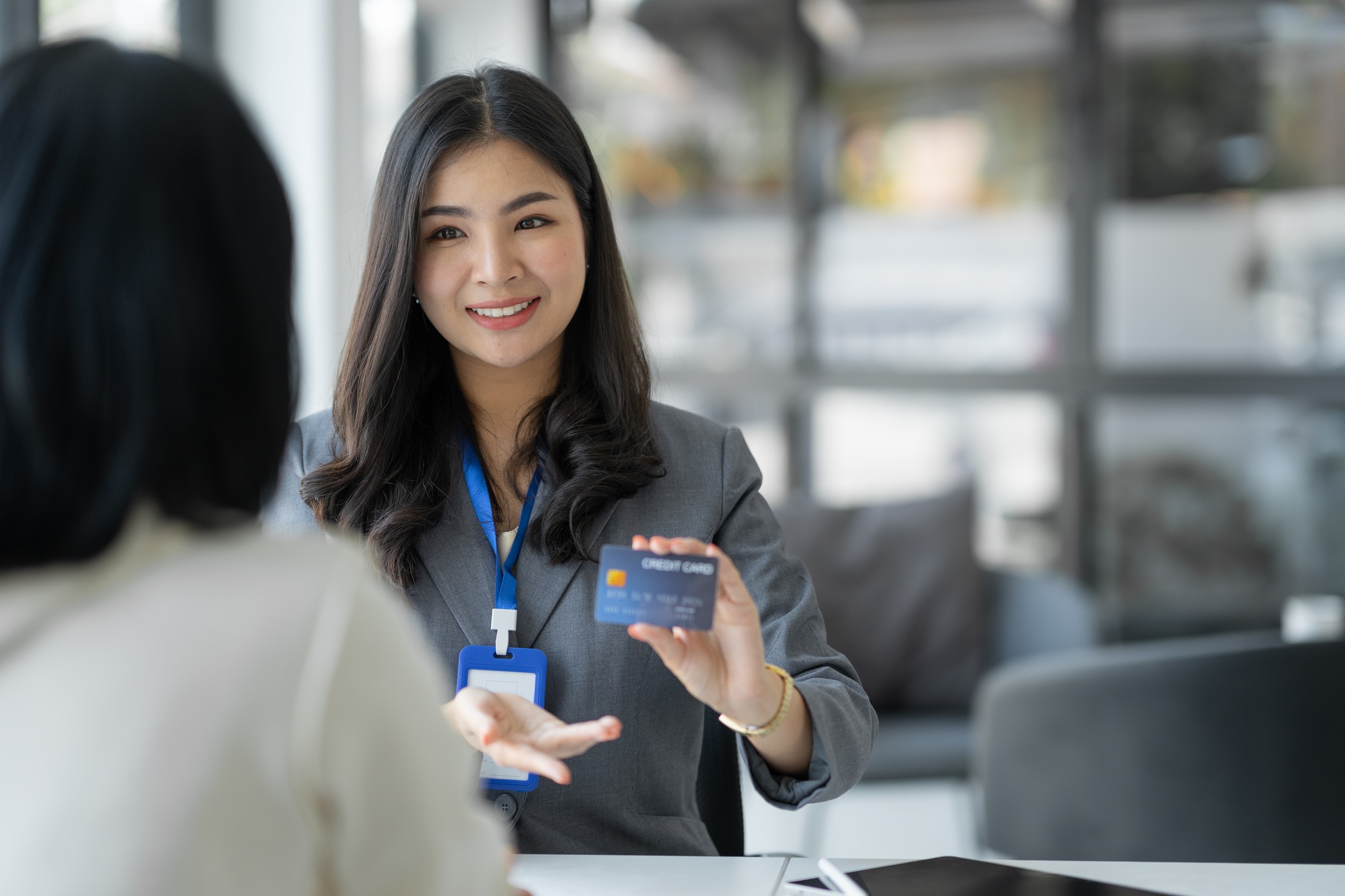 Young businesswoman, company employee presenting a form of credit limit, benefits, how to use the ca Young businesswoman, company employee presenting a form of credit limit, benefits, how to use the ca
